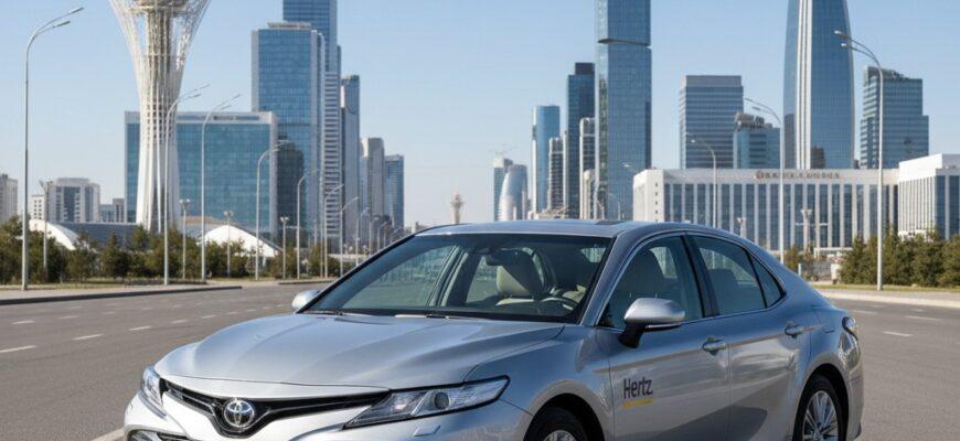 Modern rental car parked near Bayterek Tower in Astana