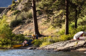 Scenic lakeside camping in Okanagan Valley with mountains and pine trees